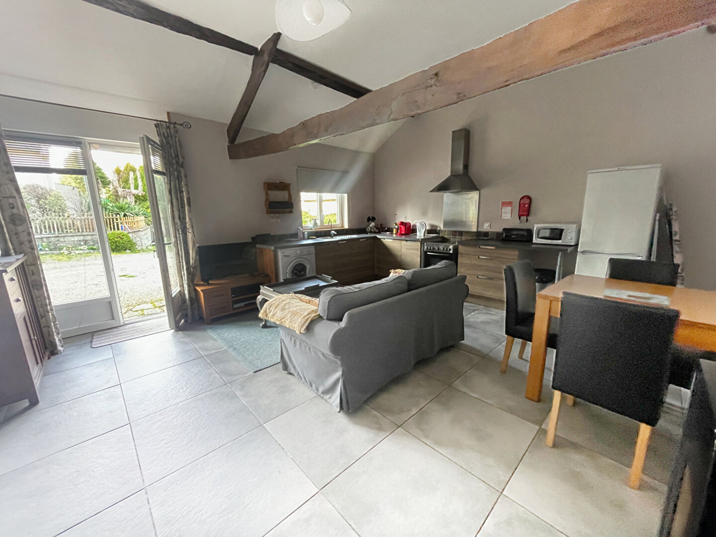 Spacious property in Finistère, Brittany, featuring a modern kitchen, living area, and outdoor access.
