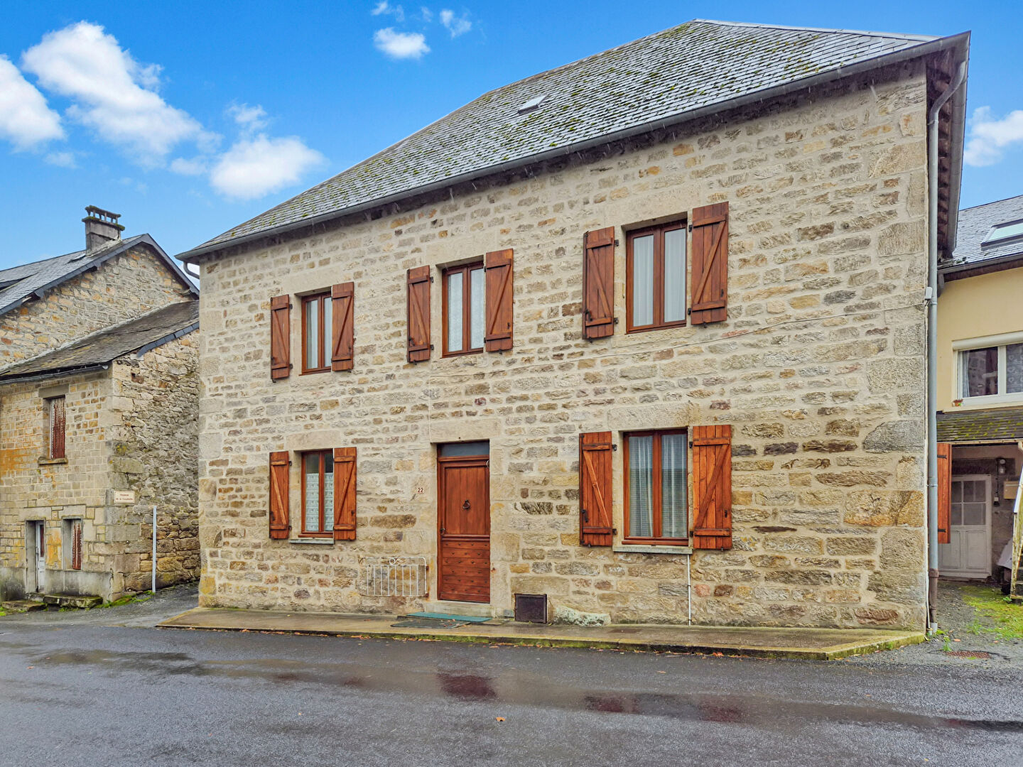 Stone property in Corrèze, Nouvelle-Aquitaine, featuring four bedrooms and traditional wooden shutters.