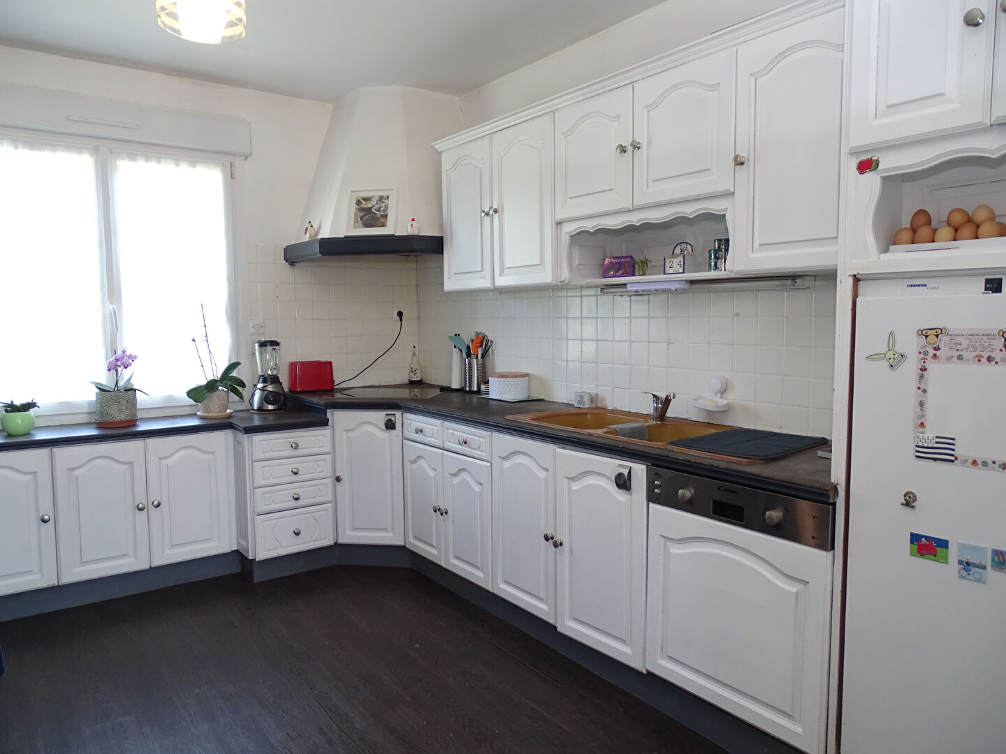 Spacious kitchen with white cabinetry and modern appliances in a property located in Finistère, Brittany, 29270.