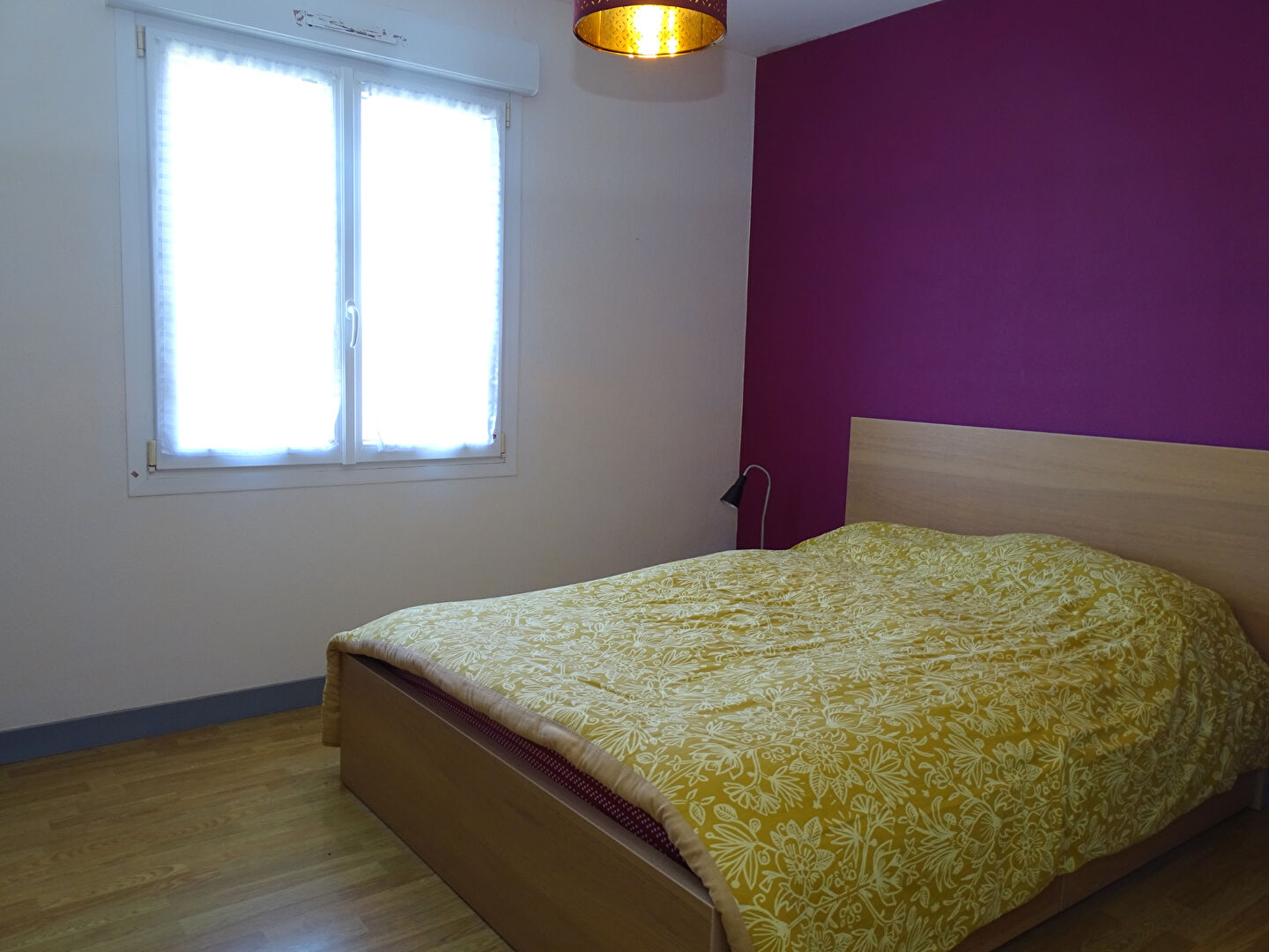 Bright bedroom featuring a double bed and window, located in Finistère, Brittany, with 4 bedrooms total.