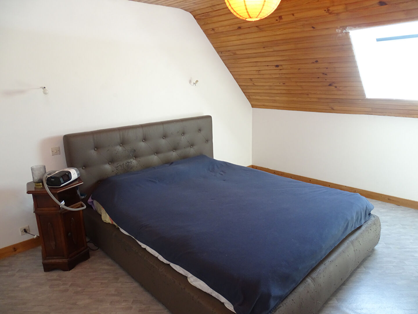 Spacious bedroom with wooden ceiling and large bed in a property located in Finistère, Brittany, 29270.