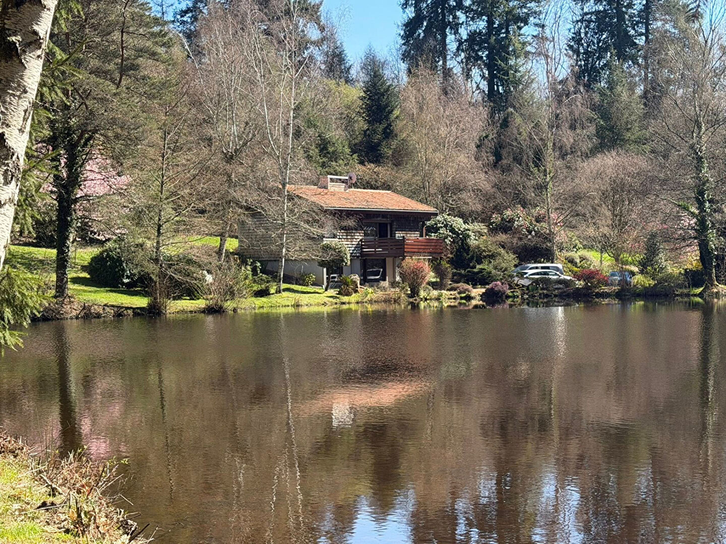 Property in Haute-Vienne, Nouvelle-Aquitaine, featuring a serene lakeside view and surrounding greenery.