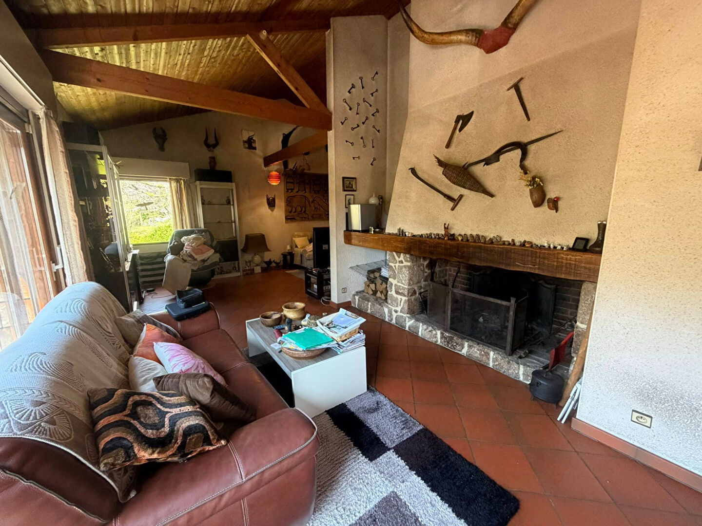 Spacious living area with a fireplace and unique decor in a property located in Haute-Vienne, Nouvelle-Aquitaine.