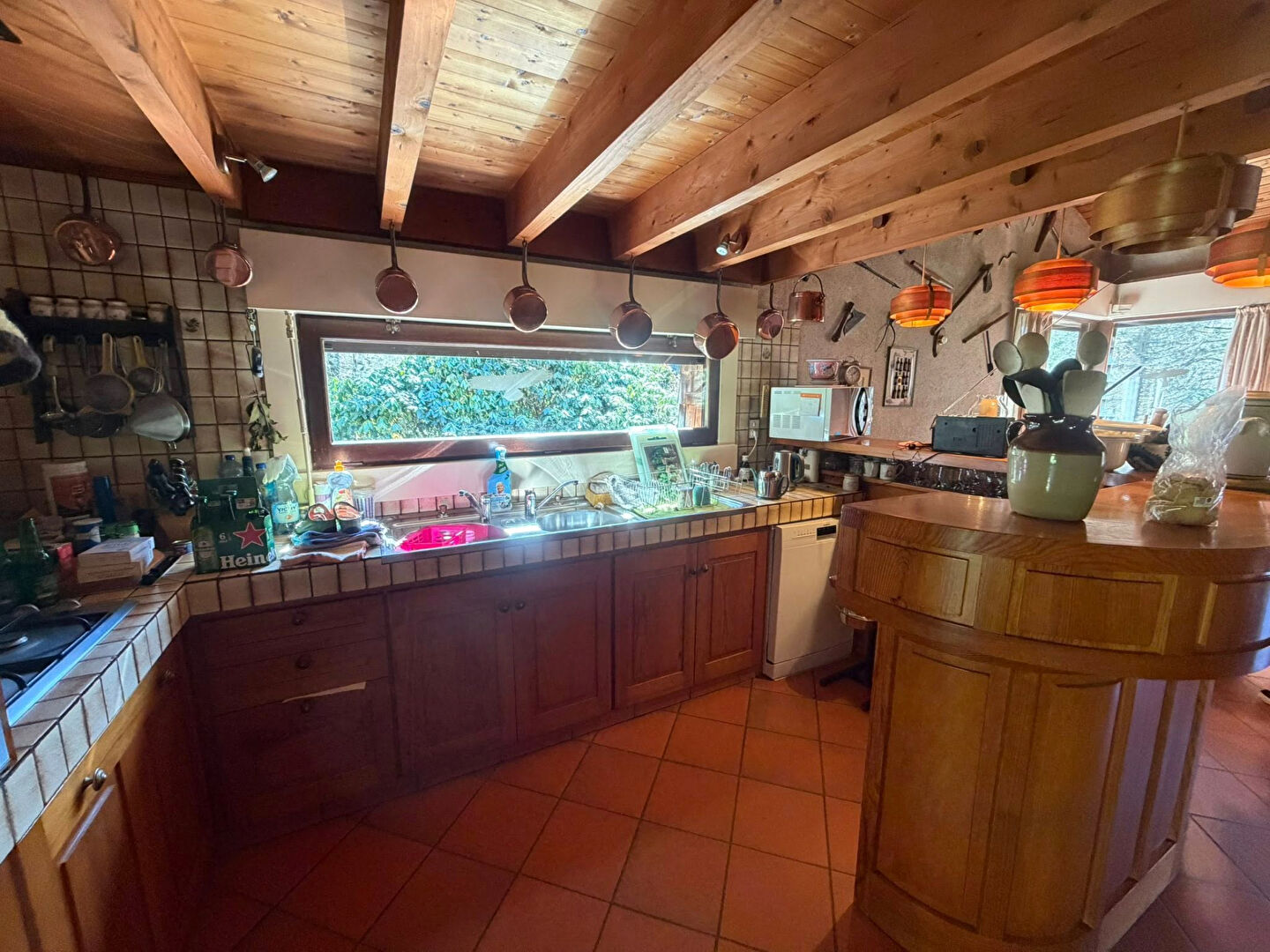 Spacious kitchen in a property located in Haute-Vienne, Nouvelle-Aquitaine, featuring wooden beams and ample counter space.