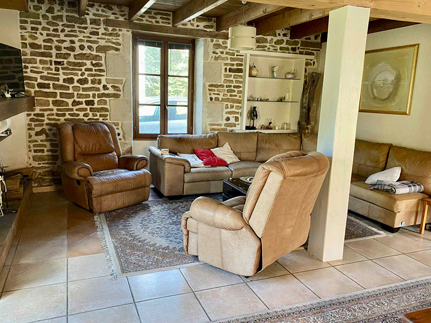 Spacious living area with comfortable seating in a property located in Charente, Nouvelle-Aquitaine, 16350, France.