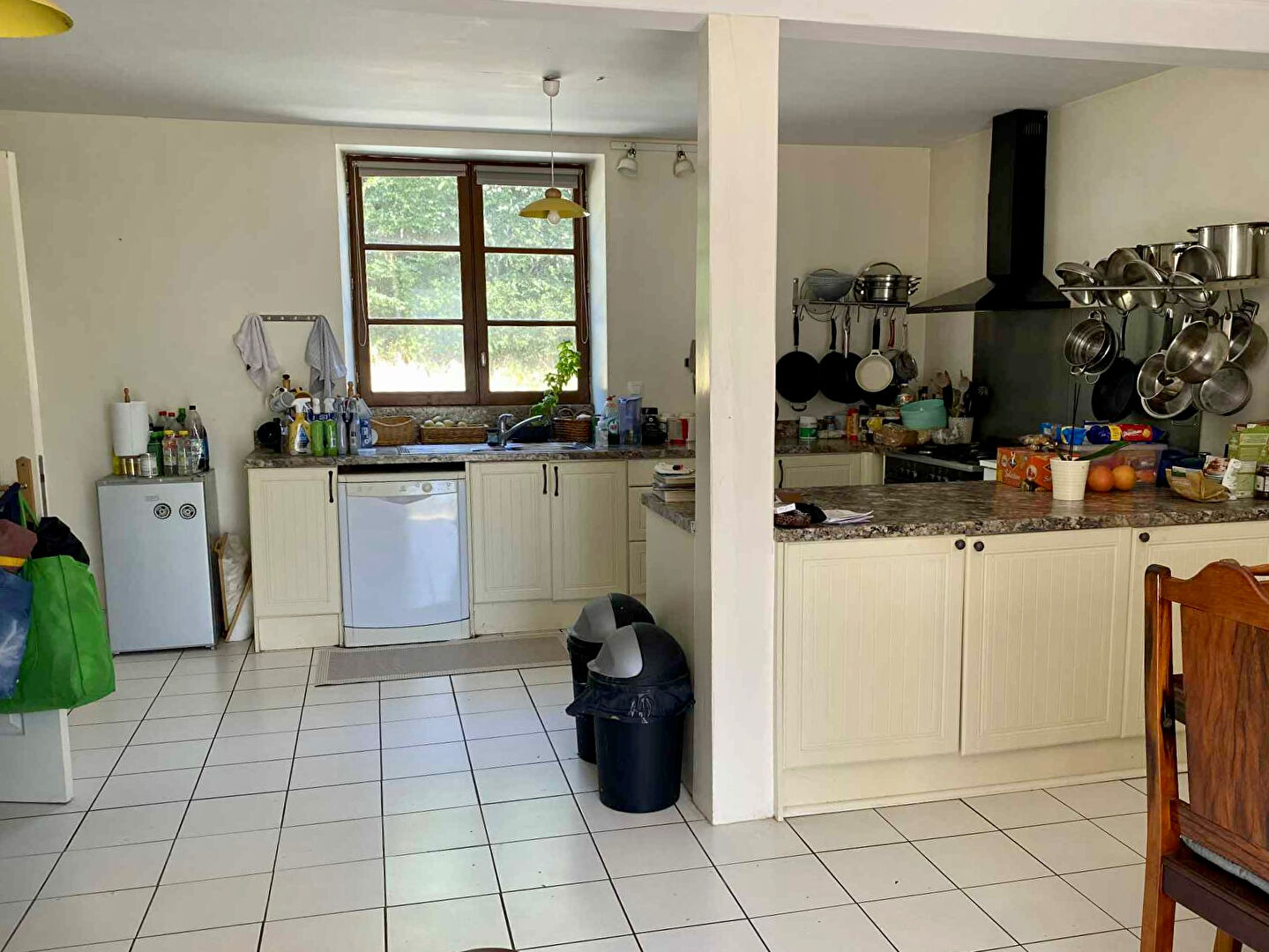 Spacious kitchen in a property located in Charente, Nouvelle-Aquitaine, featuring modern appliances and ample storage.