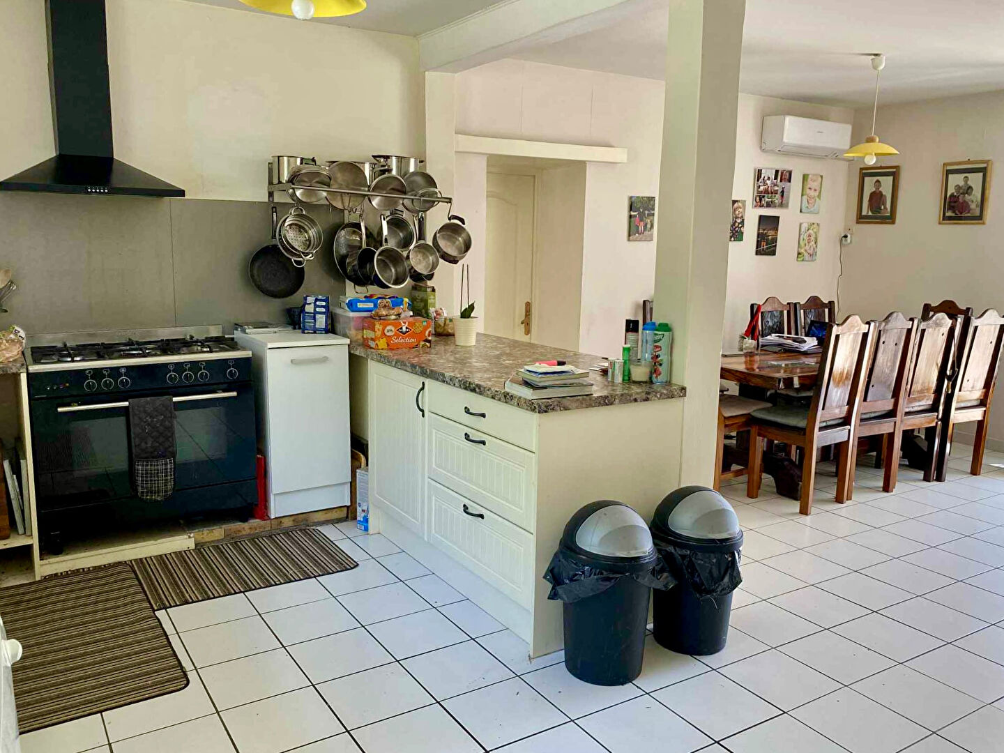Spacious kitchen and dining area in a property located in Charente, Nouvelle-Aquitaine, featuring modern appliances.