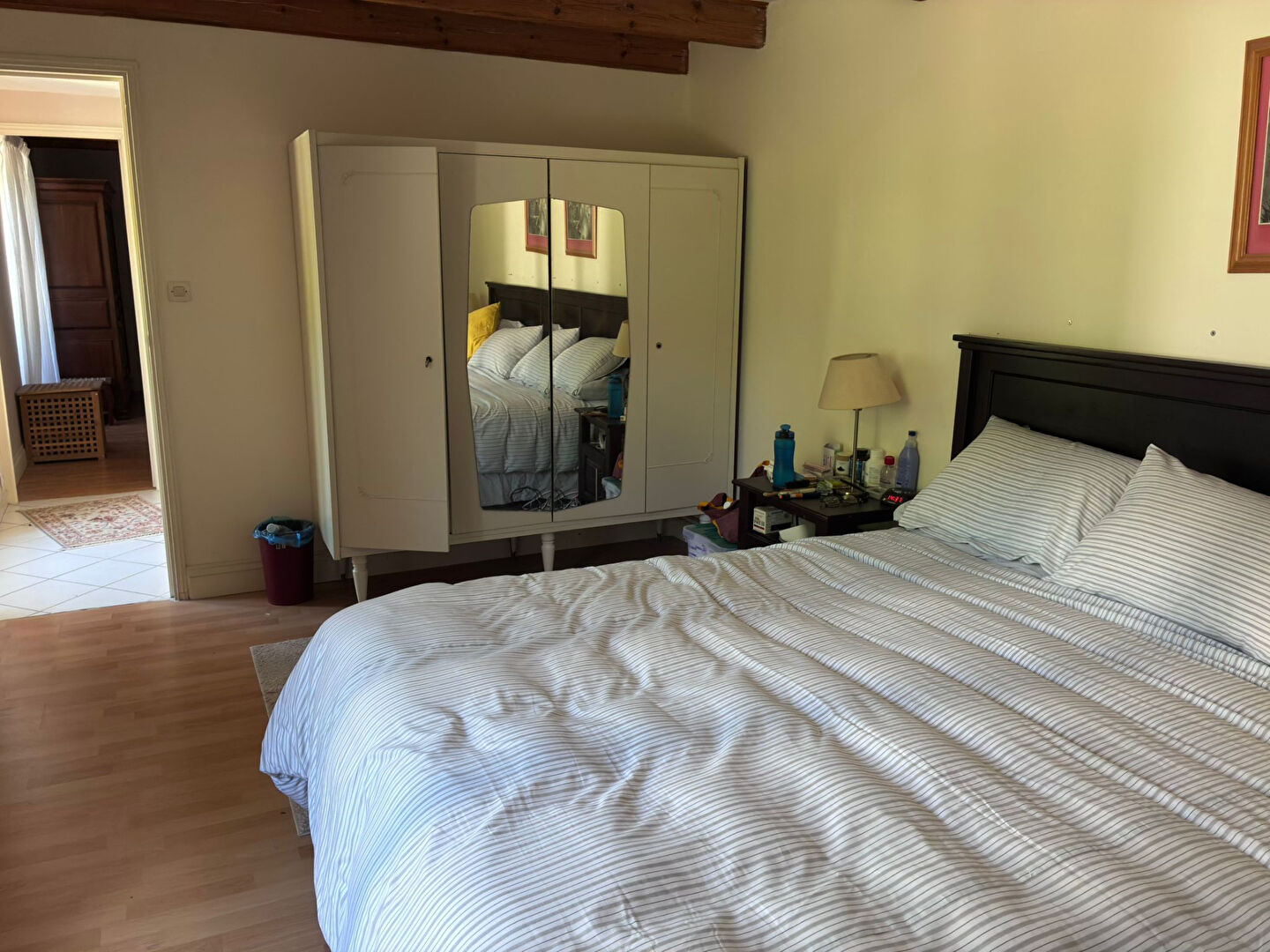 Spacious bedroom featuring a large bed and wardrobe in Charente, Nouvelle-Aquitaine, with ample natural light.