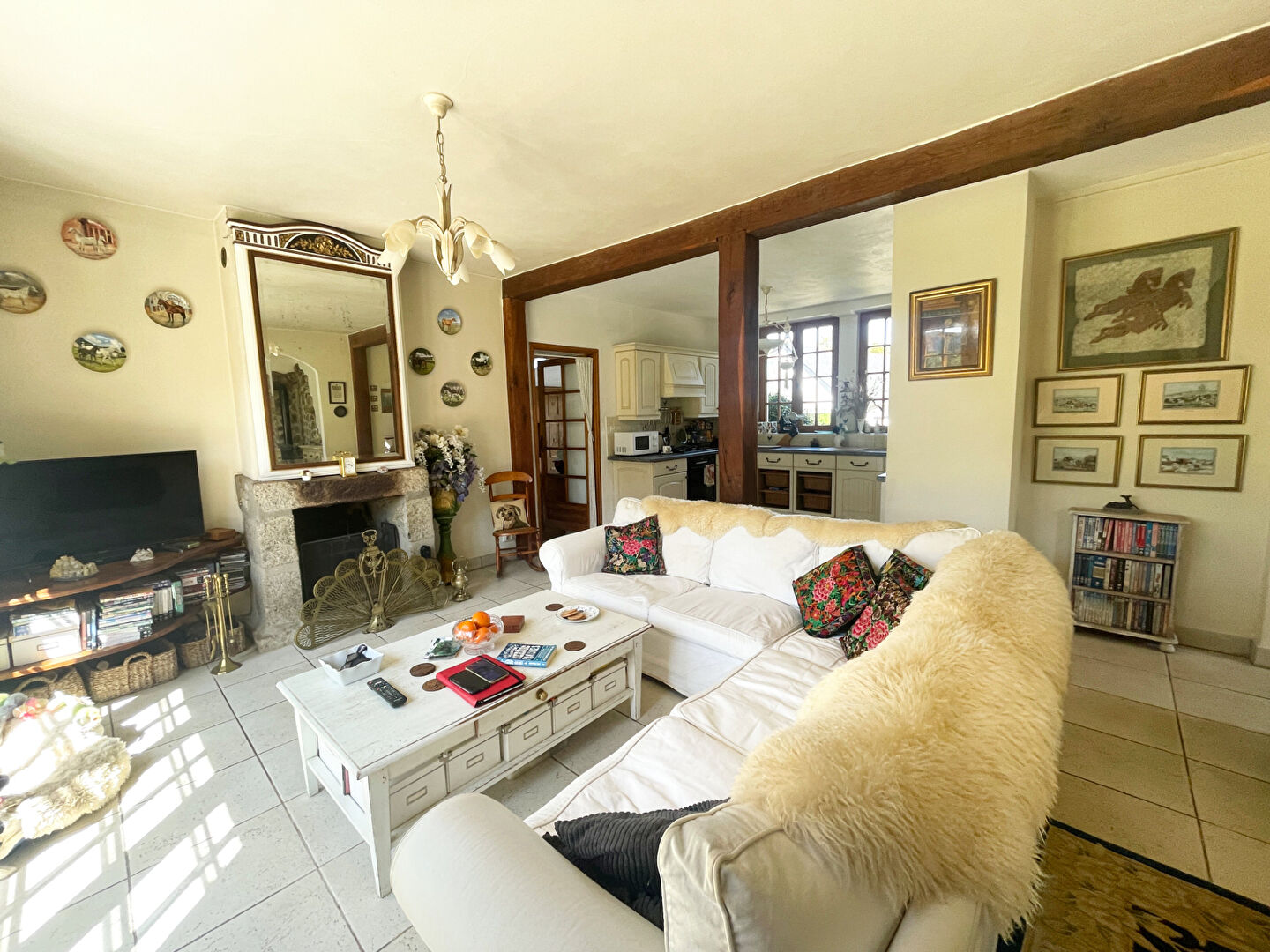 Spacious bedroom with a double bed and large windows, in a property located in Finistère, Brittany.