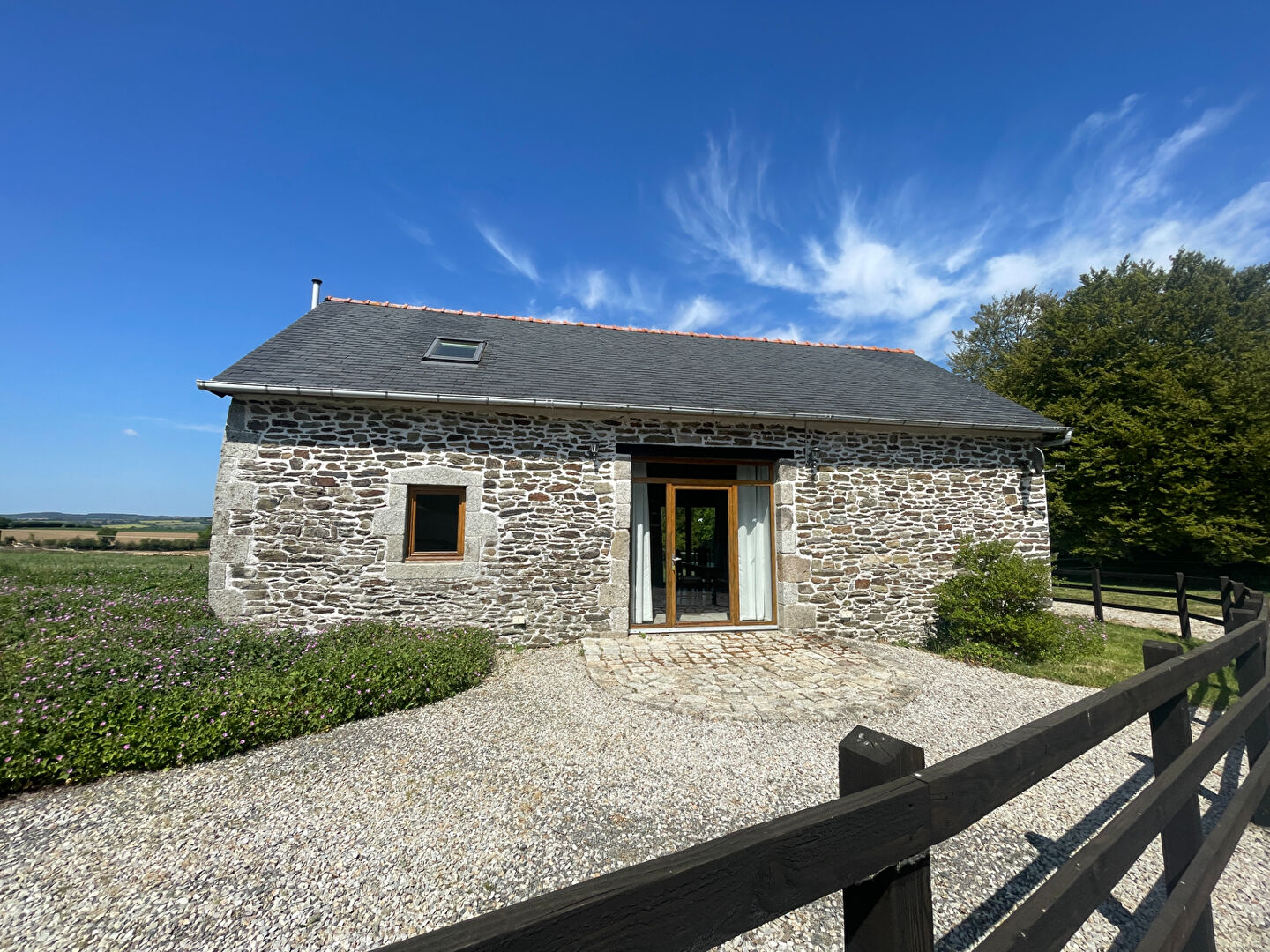 Spacious property with exposed stone walls, wooden beams, and a dining area in Finistère, Brittany, postcode 29690.