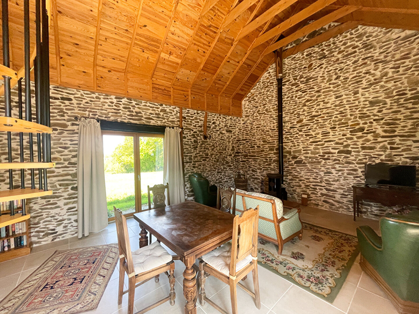 Spacious bedroom with wooden furnishings in a property located in Finistère, Brittany.