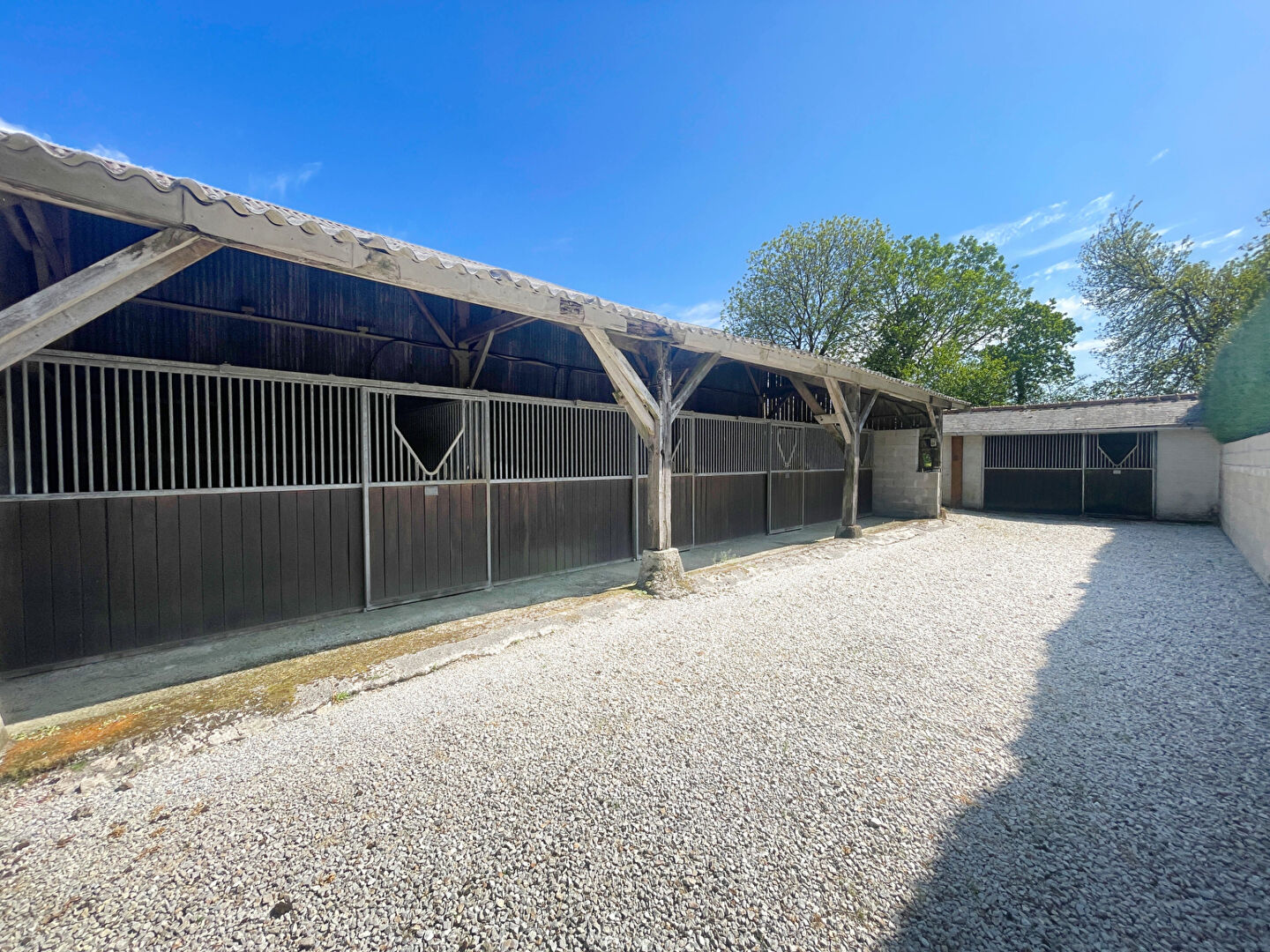 Spacious property in Finistère, Brittany, featuring a large interior area with wooden beams and sandy flooring.