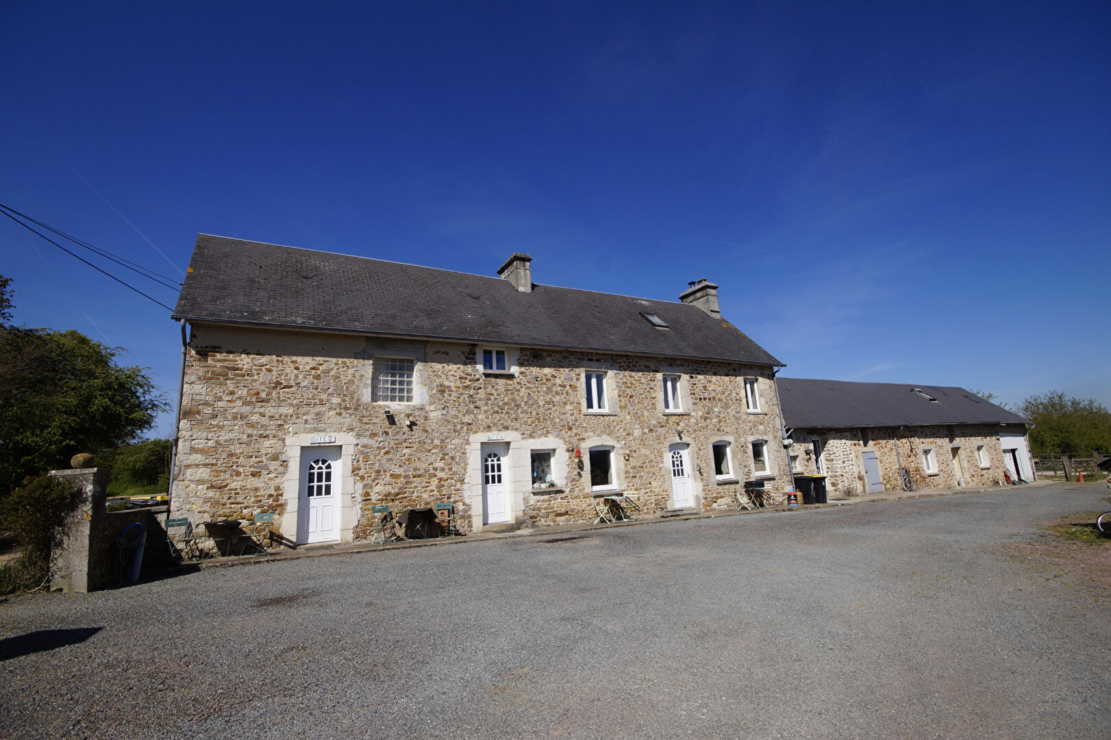 Five-bedroom property in Manche, Normandy, featuring rustic stone architecture and ample outdoor space.
