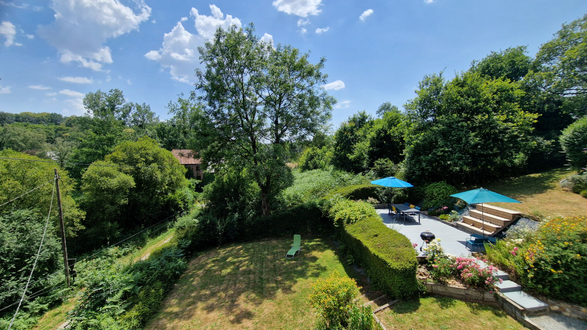 Spacious property with garden and patio area, located in Côtes-d'Armor, Brittany, featuring lush greenery and outdoor space.
