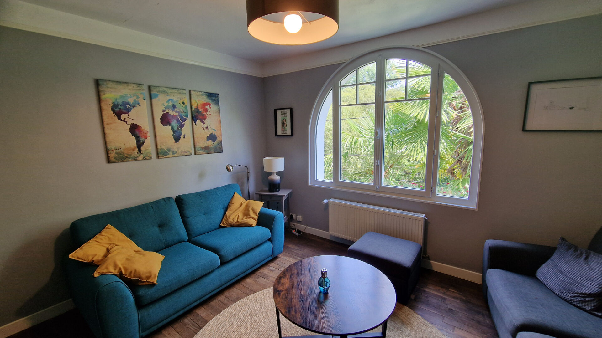 Bright living room featuring a sofa, armchair, and large window in Côtes-d'Armor, Brittany, with 4 bedrooms property.