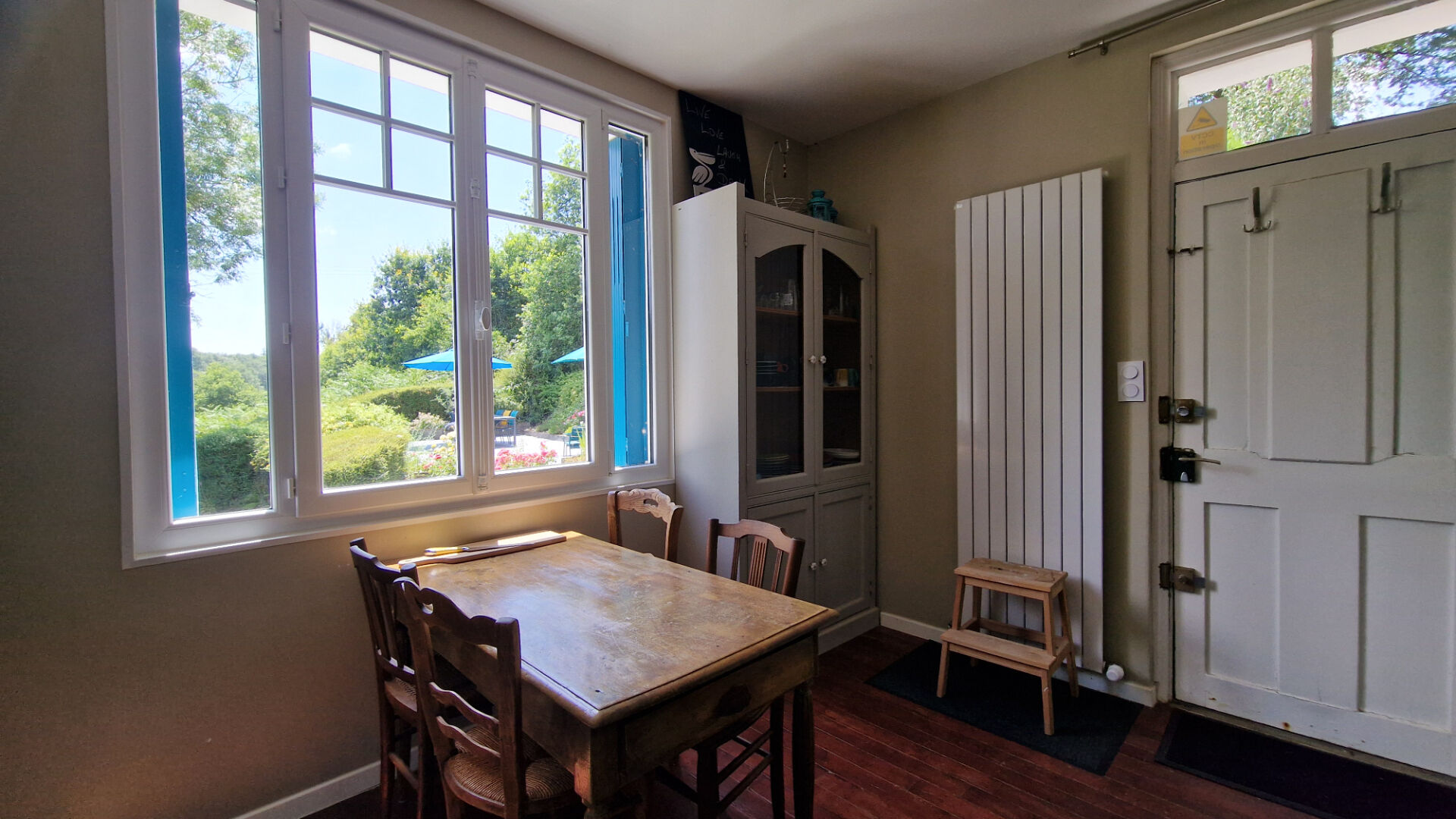 Bright dining area with a table, featuring views of the garden in Côtes-d'Armor, Brittany, 22210. Property type: property.