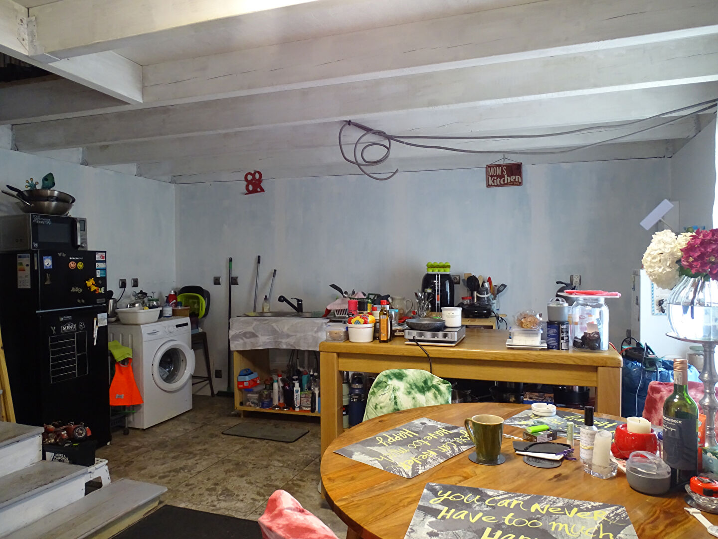 Spacious property in Finistère, Brittany, featuring a functional kitchen area with laundry and dining space.