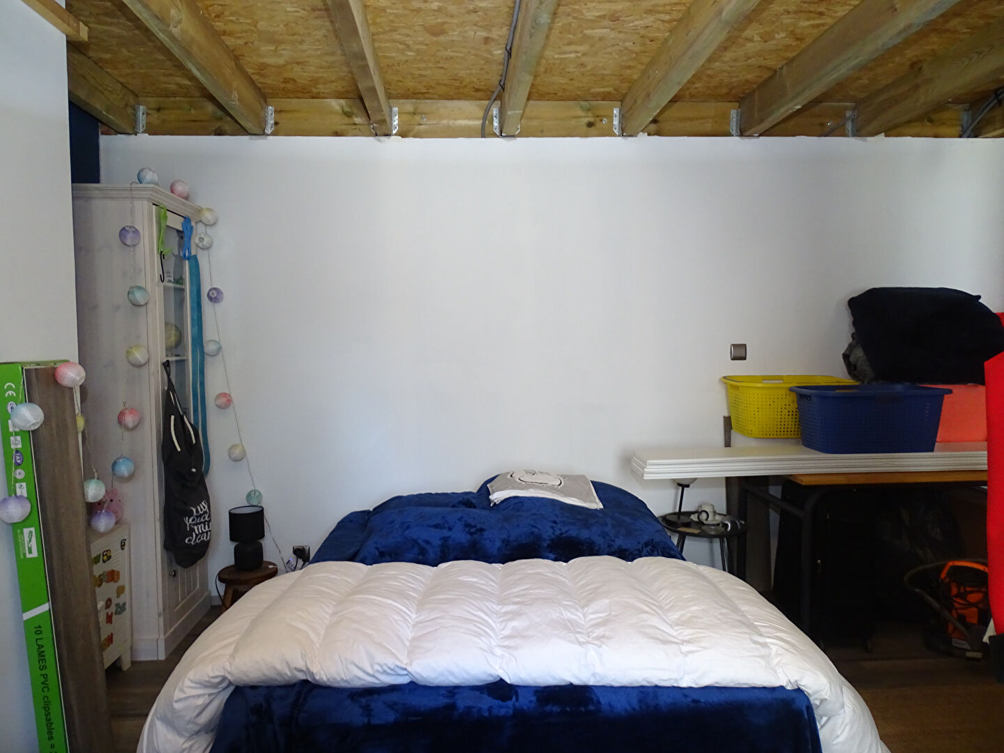 Two-bedroom property in Finistère featuring a simple interior with a bed and storage options.