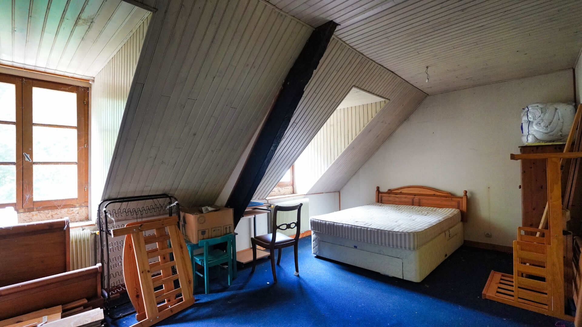 Spacious property in Morbihan, Brittany, featuring five bedrooms and sloped ceilings with natural light.