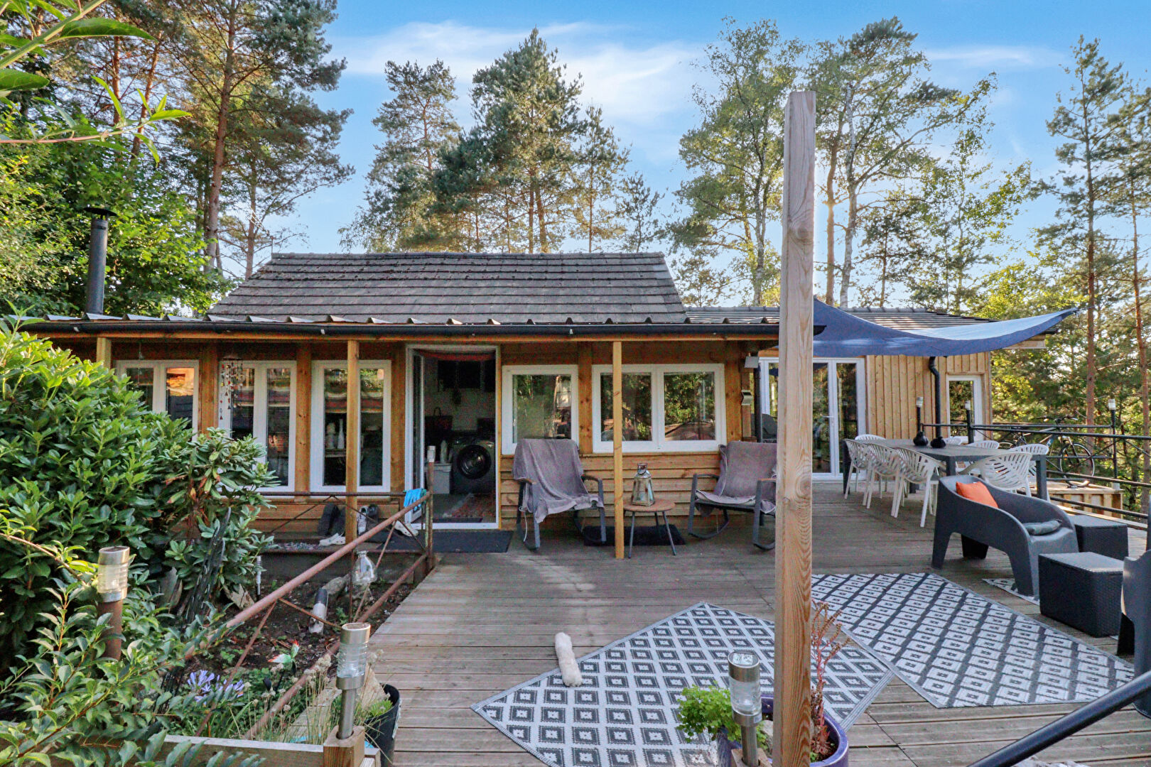 Charming property in Corrèze, Nouvelle-Aquitaine, featuring a spacious deck and surrounding greenery.