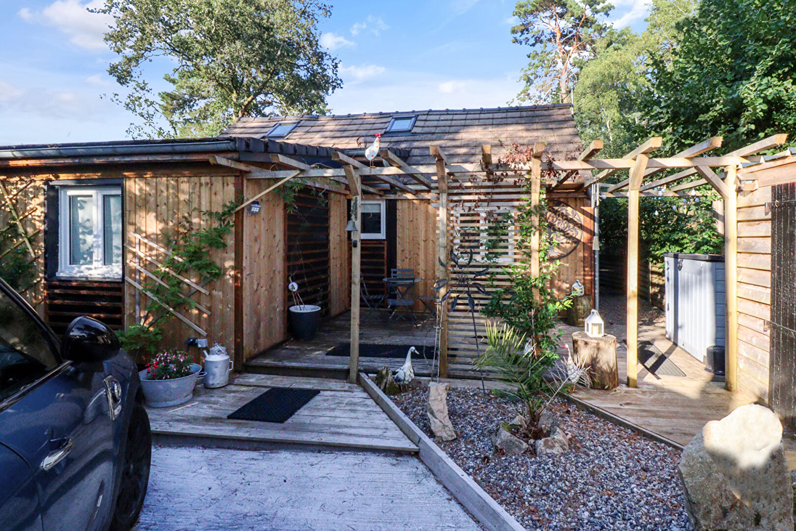 Charming property in Corrèze, Nouvelle-Aquitaine, featuring a wooden exterior and landscaped outdoor space.