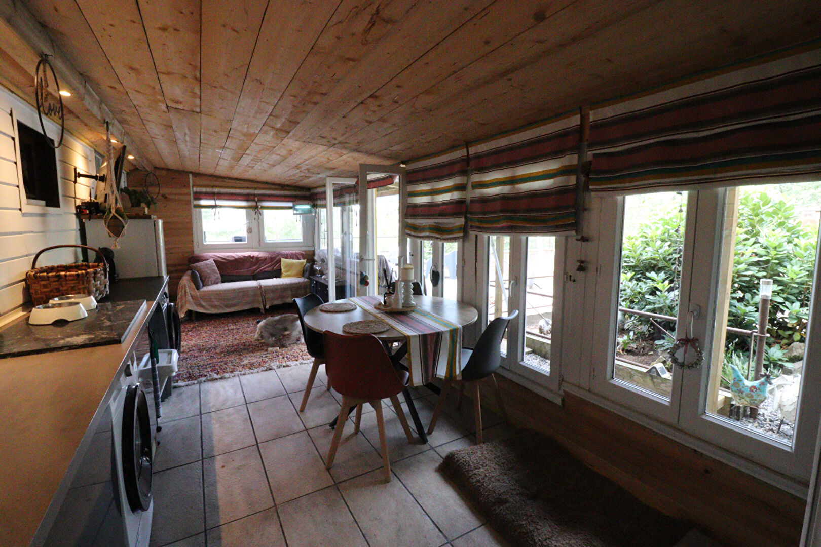 Cosy property in Corrèze, Nouvelle-Aquitaine, featuring a modern kitchen, dining area, and natural light from large windows.