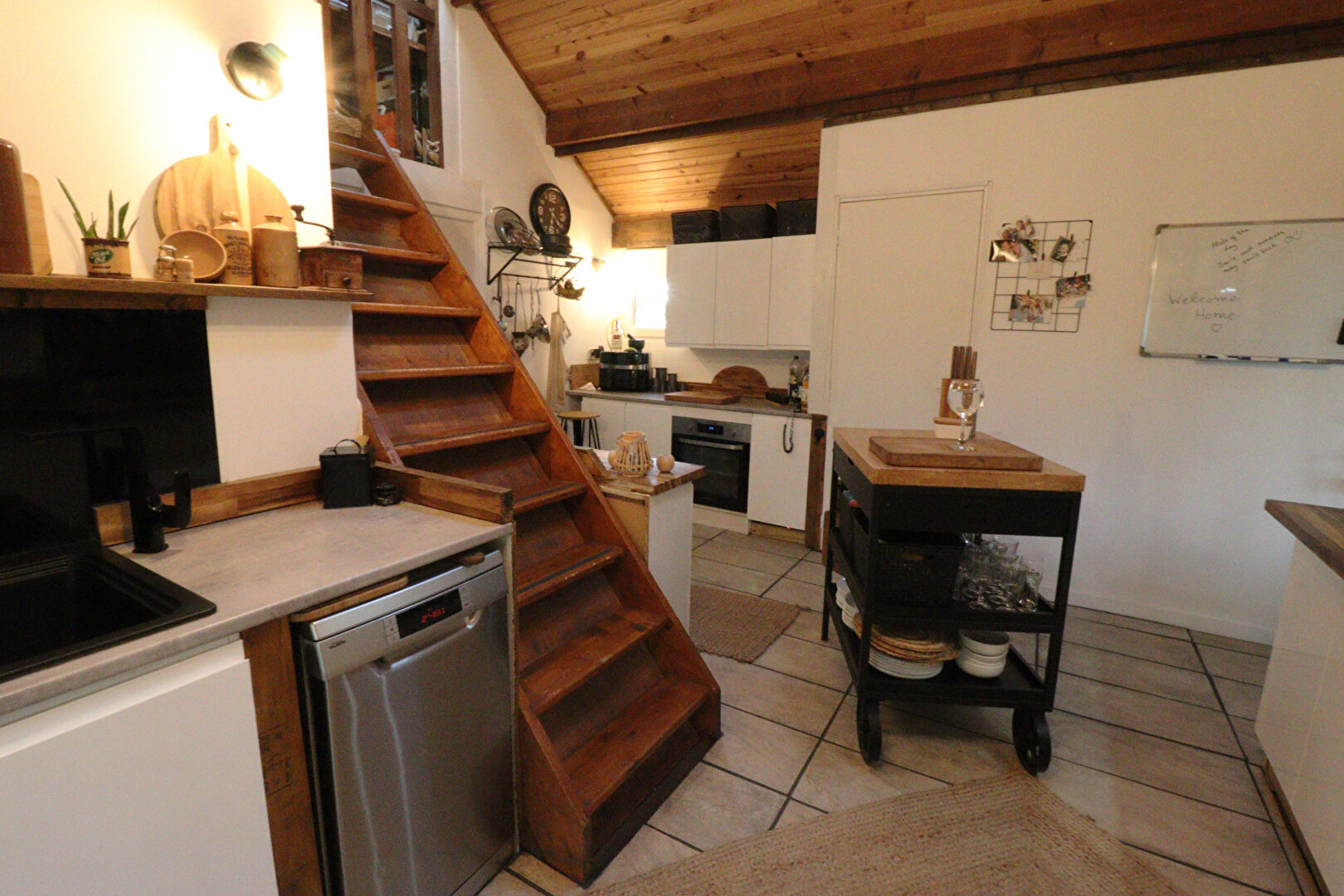 Charming property in Corrèze, Nouvelle-Aquitaine, featuring a wooden staircase and modern kitchen amenities.