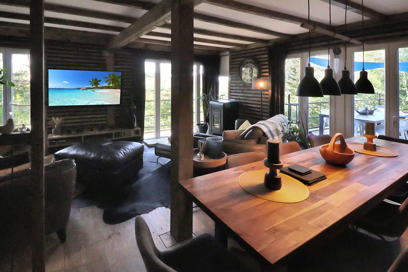 Spacious property in Corrèze, Nouvelle-Aquitaine, featuring a dining area and modern decor with large windows.