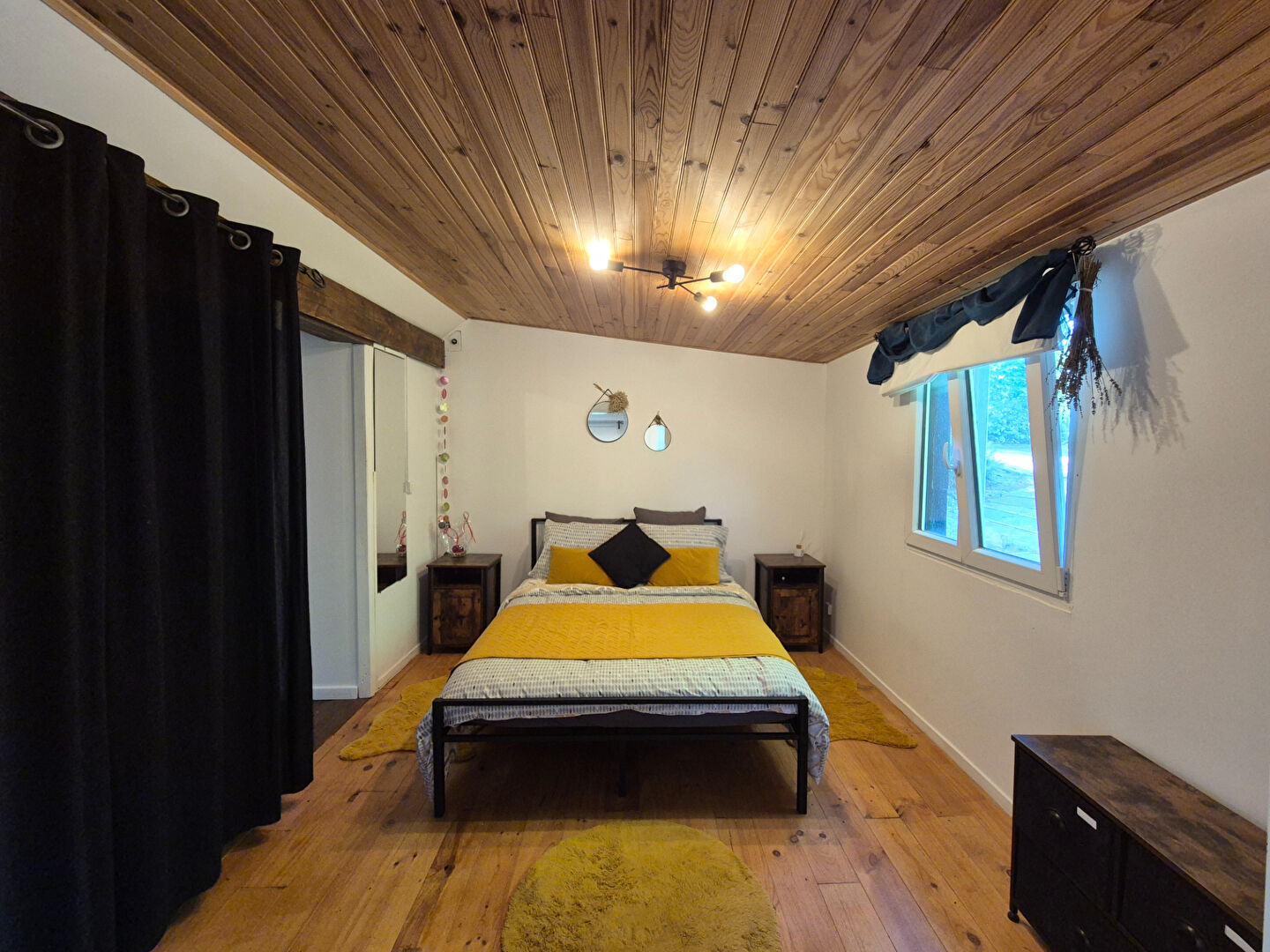 Three-bedroom property in Corrèze, Nouvelle-Aquitaine, featuring a wooden ceiling and natural light from large windows.