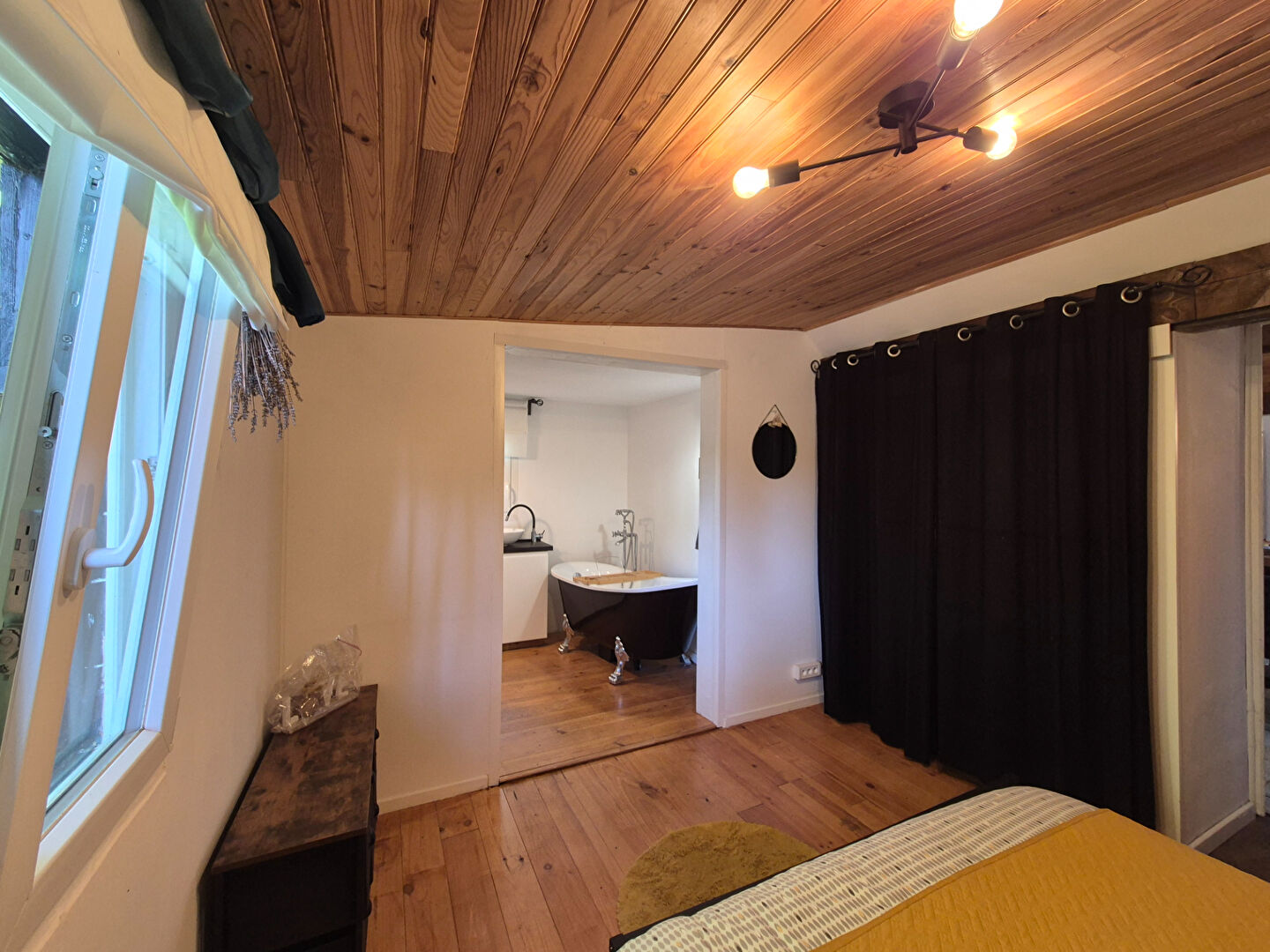 Spacious property interior featuring wooden ceiling, three bedrooms, and adjoining bathroom in Corrèze, Nouvelle-Aquitaine.