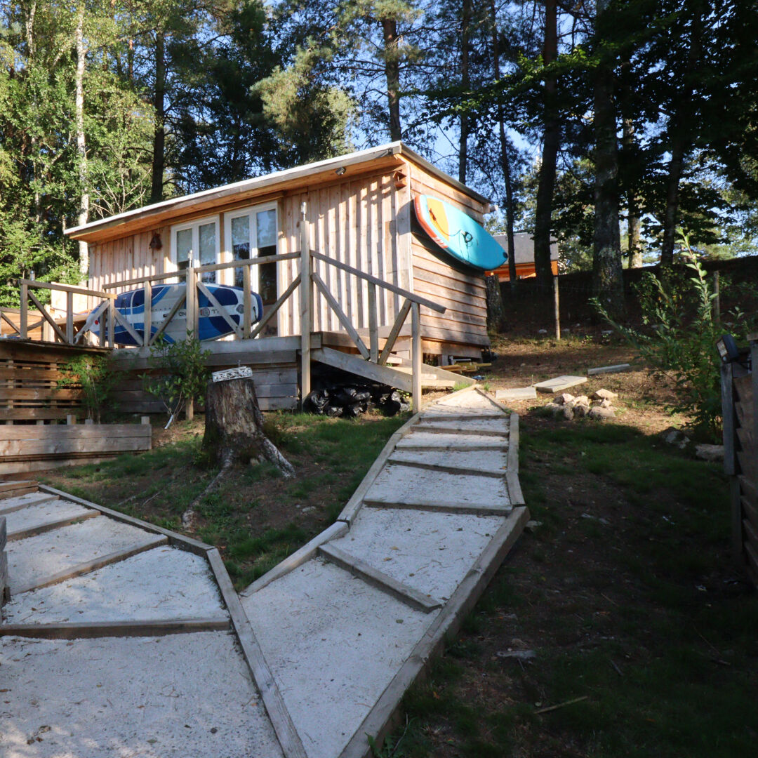 Wooden property with a terrace and kayak, set in a wooded area in Corrèze, Nouvelle-Aquitaine, postcode 19320.