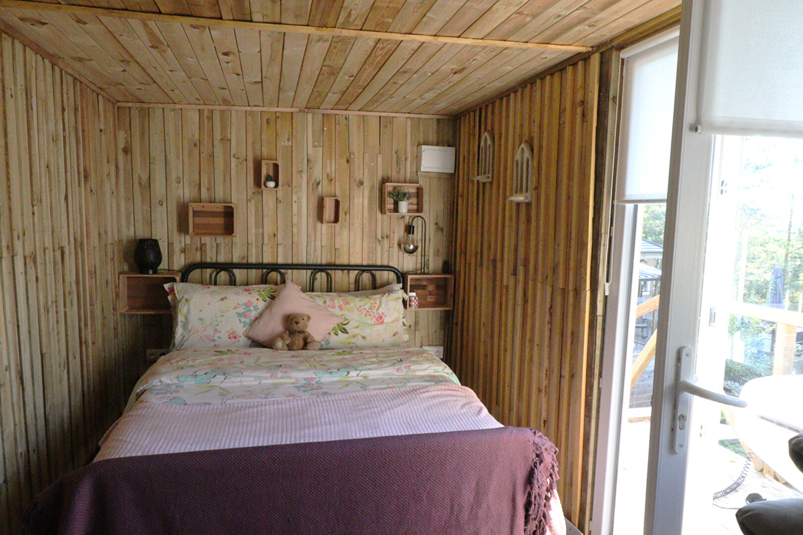 Cozy property in Corrèze, Nouvelle-Aquitaine, featuring wooden walls and a comfortable bedroom with a double bed.
