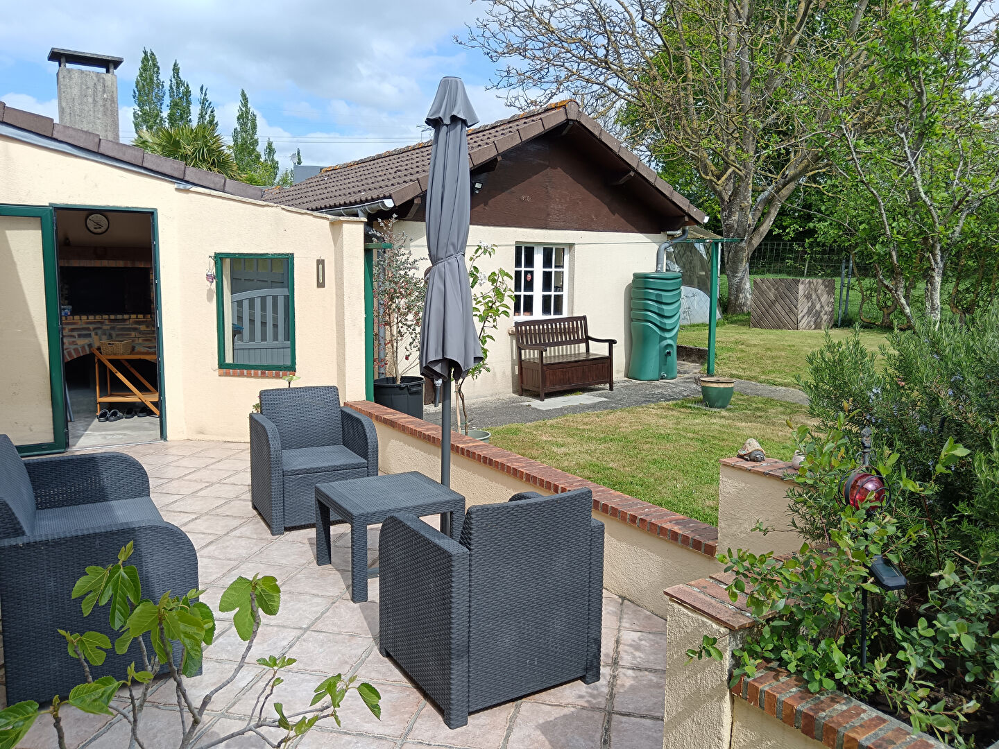 Spacious property in Manche, Normandy, featuring a garden, terrace, and seating area for outdoor relaxation.