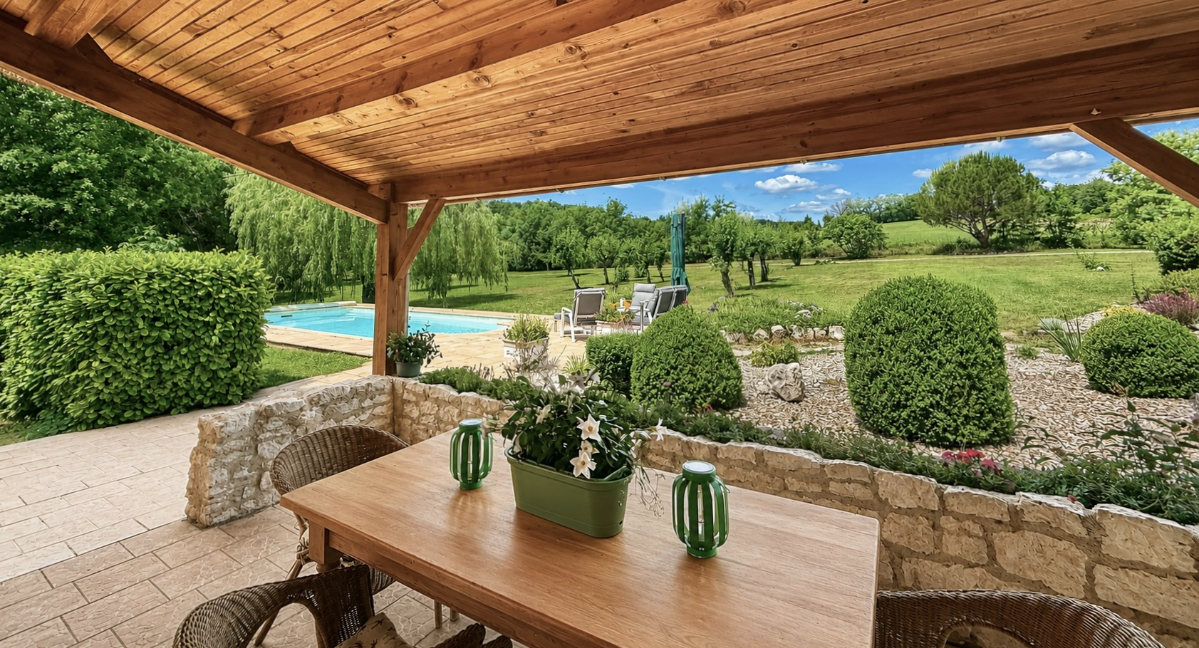 Spacious property in Tarn-et-Garonne, Occitanie, featuring a swimming pool and inviting living area with wooden beams.