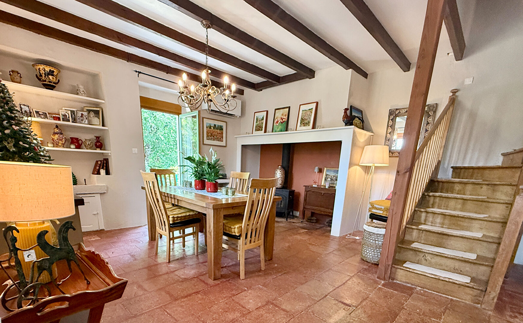 Spacious property in Tarn-et-Garonne, Occitanie, featuring a dining area, decorative fireplace, and indoor plants.