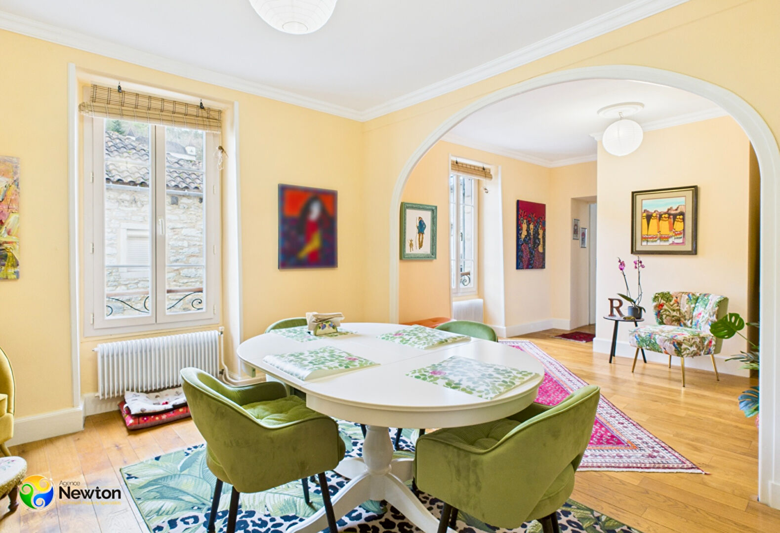 Bright dining area featuring a round table and green chairs in a property located in Lot, Occitanie, 46220, France.