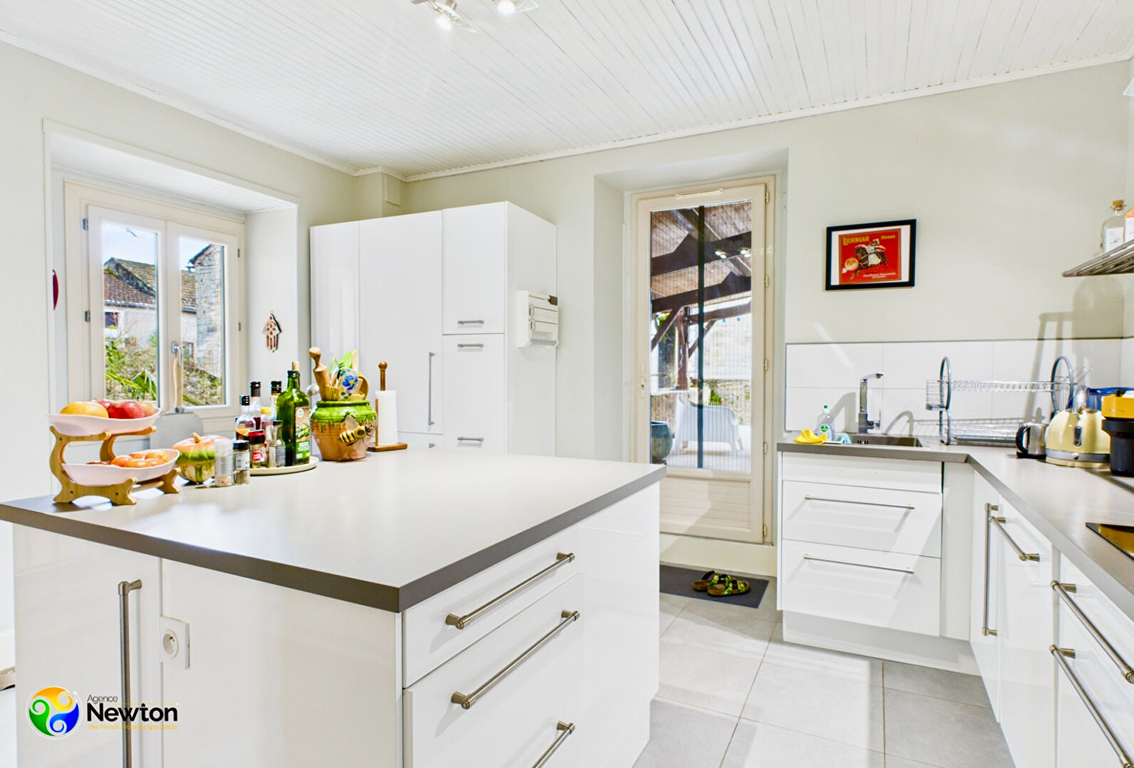 Modern kitchen in property located in Lot, Occitanie, featuring sleek cabinetry and ample natural light.