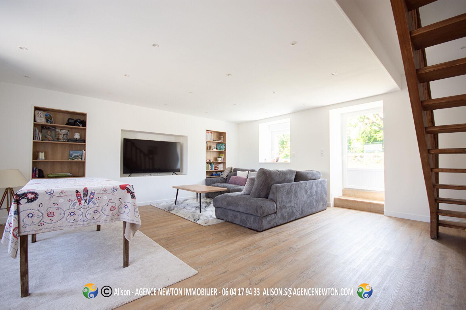 Spacious living area in a property located in Manche, Normandy, featuring large windows and modern furnishings.