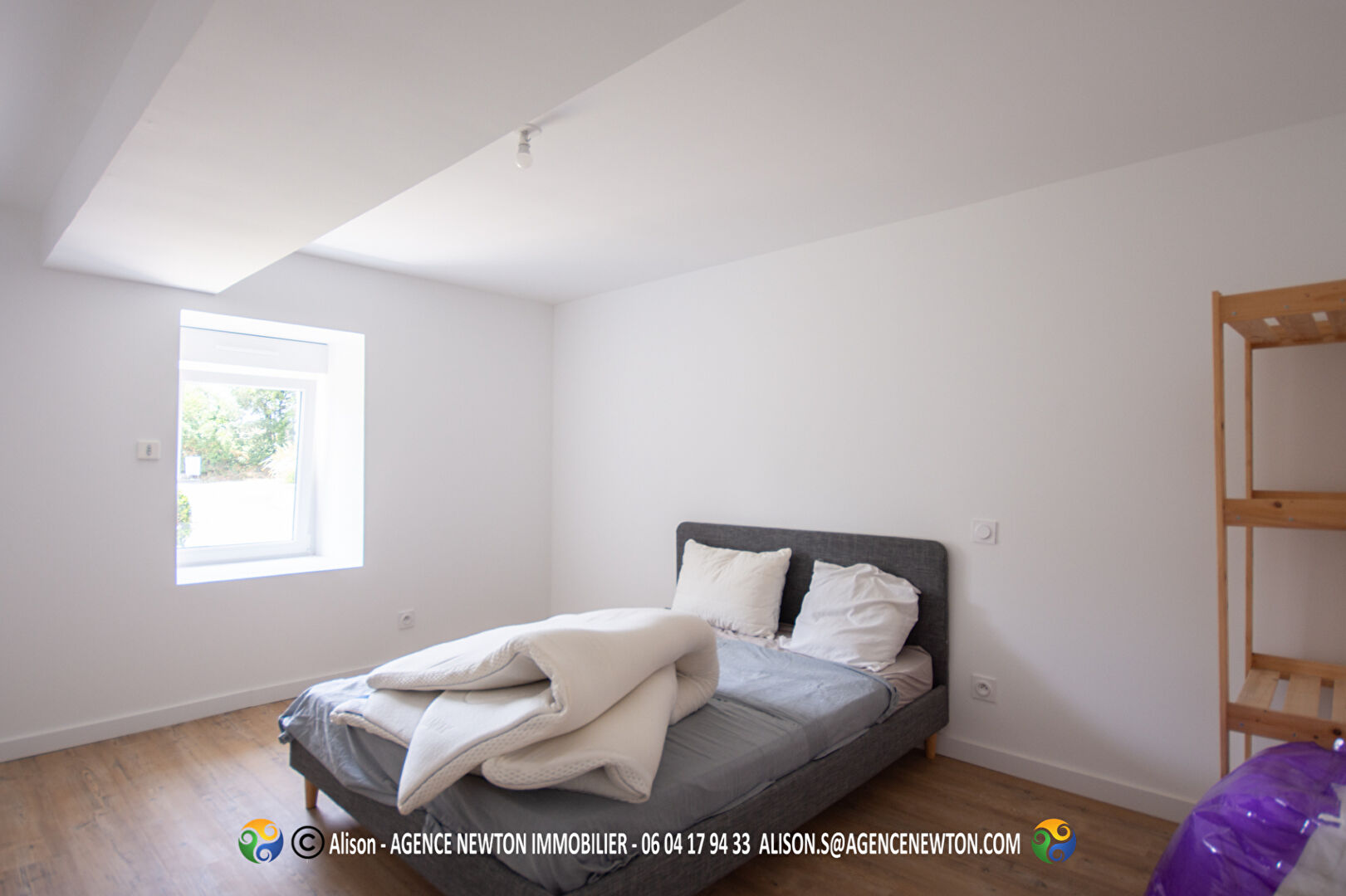 Spacious bedroom in a property located in Manche, Normandy, featuring natural light and wooden flooring.