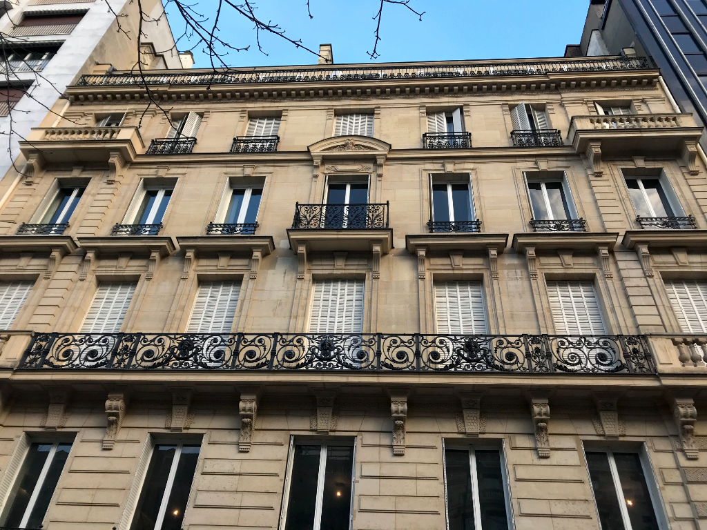 Elegant property facade featuring ornate balconies in Paris, Île-de-France, postcode 75008.