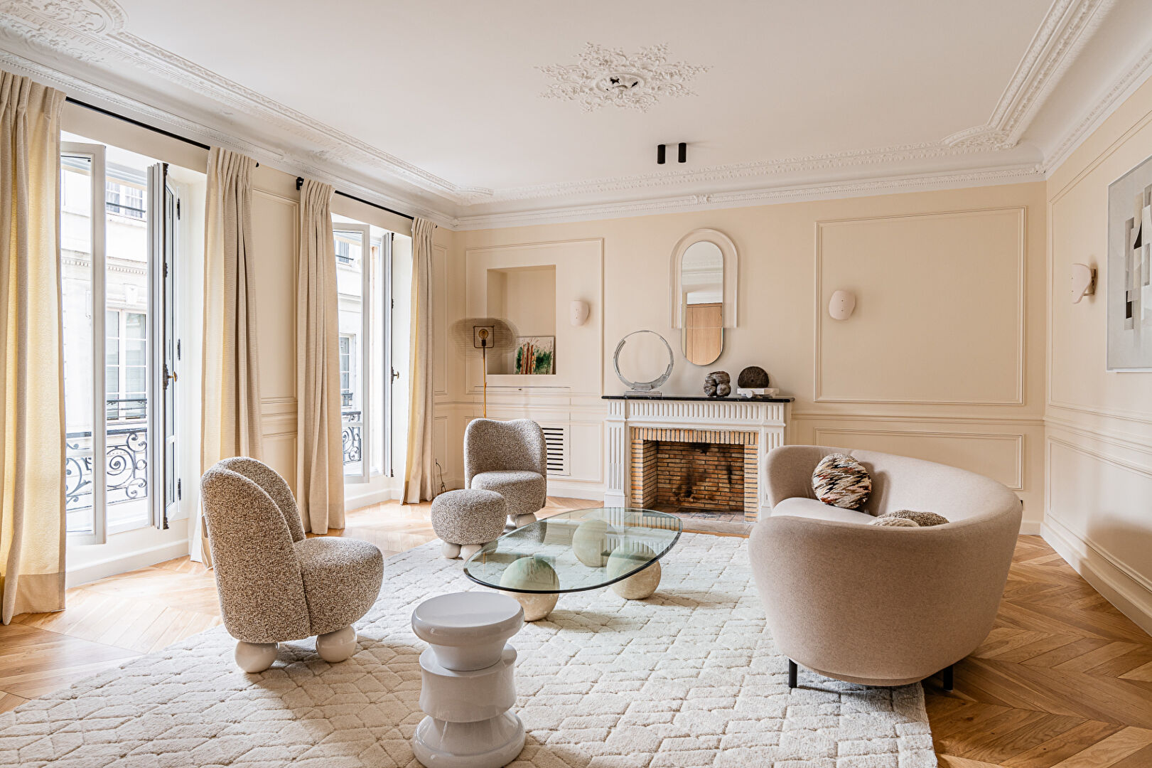 Bright and spacious property in Paris, Île-de-France, featuring a cosy lounge with elegant decor and a fireplace.